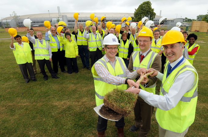 Building contractors and Diamond staff celebrate as lead architect for I13, Paul Prince (STFC), Principal Beamline Scientist for I13, Prof. Christoph Rau, and Diamond's Physical Sciences Director, Prof. Trevor Rayment, make the first cut into the turf to make way for I13.