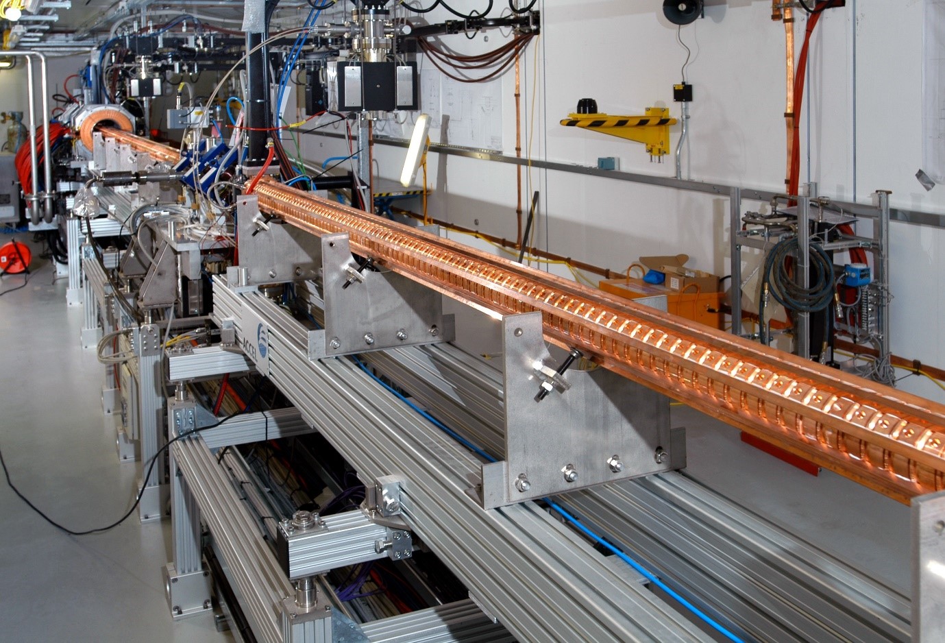 The linac, with the gun at the far end and the accelerating structures coming towards us. The electrons are already more than 0.95 times the speed of light by the time they emerge from the copper rings at the back.