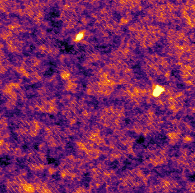 Fig. 2. An experimental plan-view ADF-STEM image showing Cs+ (bright dots) islands observed from a Cs+ exchanged twisted bilayer biotite.