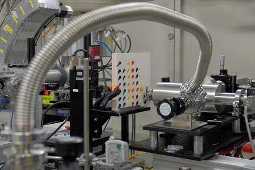Experimental setup on B18 beamline. In the centre of the picture the test panel with 41 oil-based artist's paints studied. On the right the annular PN-Detector’s Rococo-2 four-channel silicon drift detector (SDD), used for EDXRD data acquisition. Incident X-ray beam arrives from right side and passes through the central aperture in the detector to impinge on the samples.