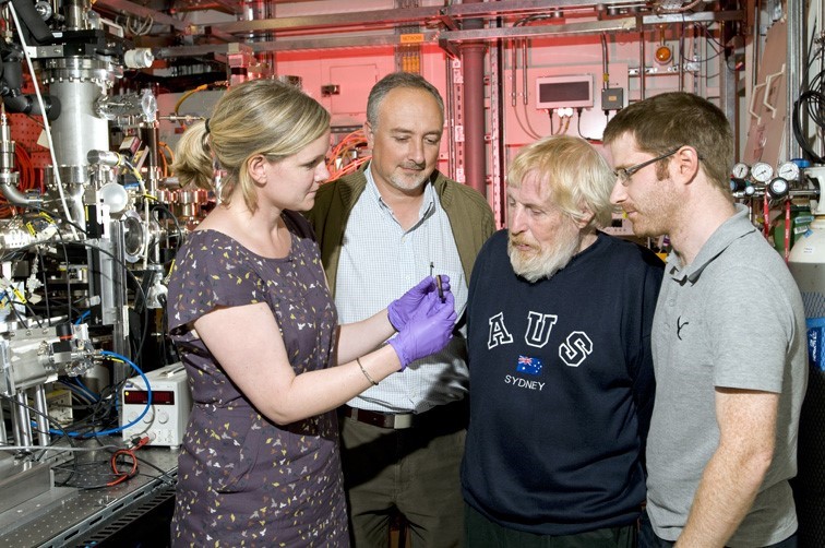 From left to right: In Diamond Beamline, Prof. Eleanor Schofield, Head of Conservation and Collections Care for the Mary Rose Trust shows a wood sample to Principal Beamline Scientist at Diamond Light Source, Dr Giannantonio Cibin, Prof. Alan Chadwick, University of Kent and Dr Stephen Parry, Senior Support Scientist at Diamond Light Source.   