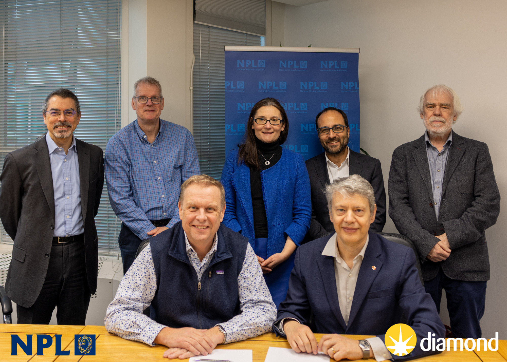 From L to R: (Front Row) CEOs Dr Peter Thompson (NPL) and Prof. Gianluigi Botton (Diamond), and (Second Row) Dr Richard Burguete Postgraduate Institute Director (NPL),  Dr JT Janssen, Chief Scientist (NPL), Isabelle Boscaro-Clark, Head of Impact, Communications and Engagement (Diamond), Dr Adrian Mancuso, Physical Sciences Director (Diamond), and Prof. Sir Dave Stuart FRS, Life Sciences Director (Diamond)