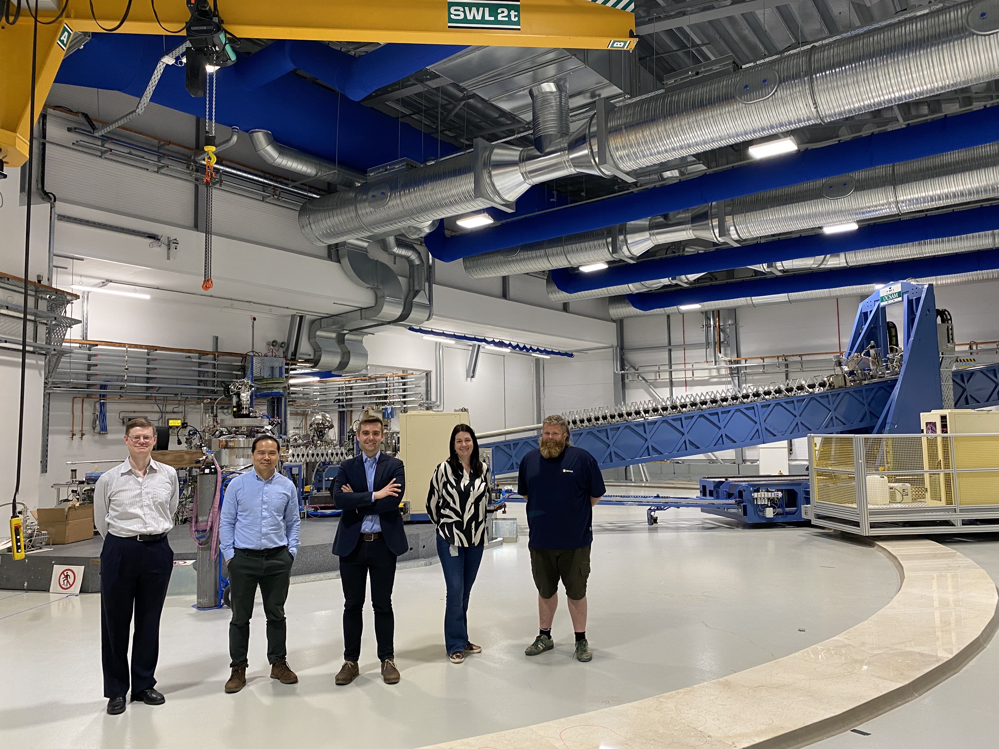 Robert House and the I21 beamline team in the I21 experimental hall.<br/>(L to R: Stefano Agrestini, beamline scientist on I12, Kejin Zhou, principal beamline scientist on I21, Robert House, 30 under 30 finalist and I21 user, Mirian Garcia Fernandez, beamline scientist on I21, Thomas Rice, senior mechanical beamline technician on I21)