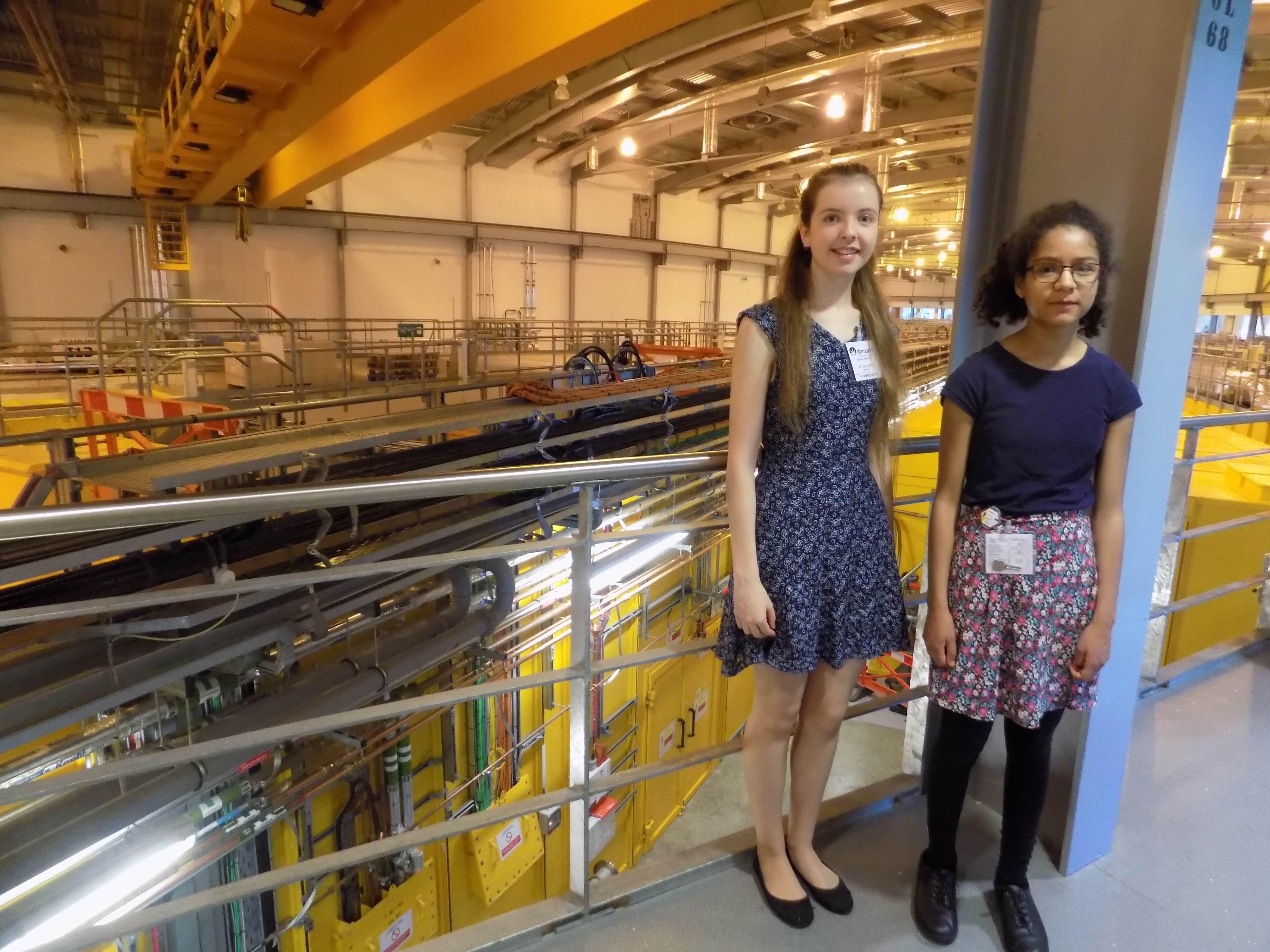 Danielka and Emelia (Health Physics) overlooking the experimental hall floor.