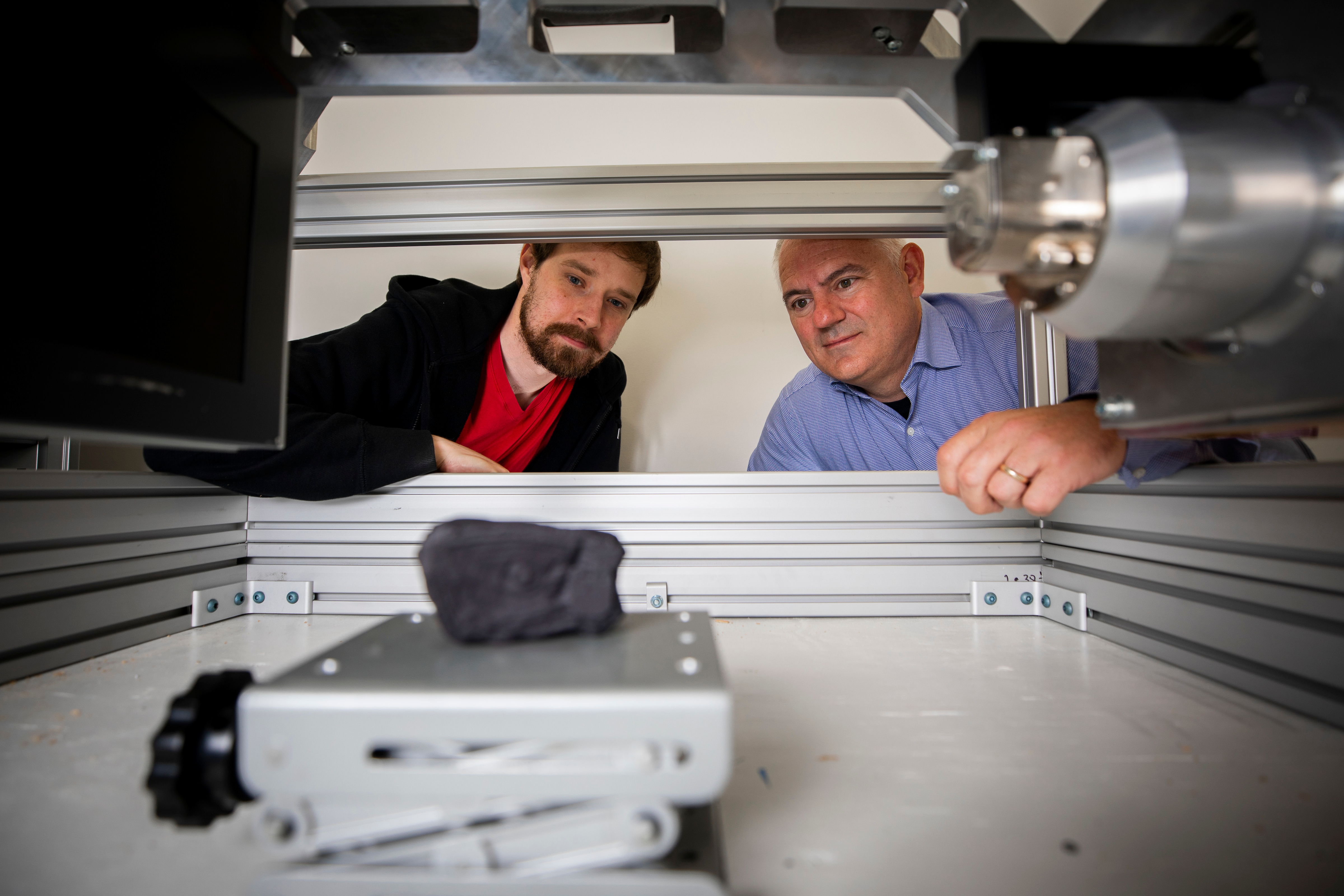 Brent Seales and Seth Parker (Digital Restoration Initiative project lead) scanning a replica of the Herculaneum scroll. Credit: UK Photo