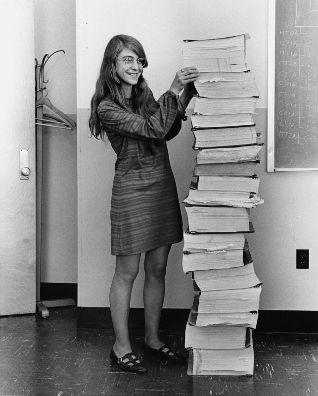 Hamilton in 1969, standing next to listings of the software she and her MIT team produced for the Apollo project.
