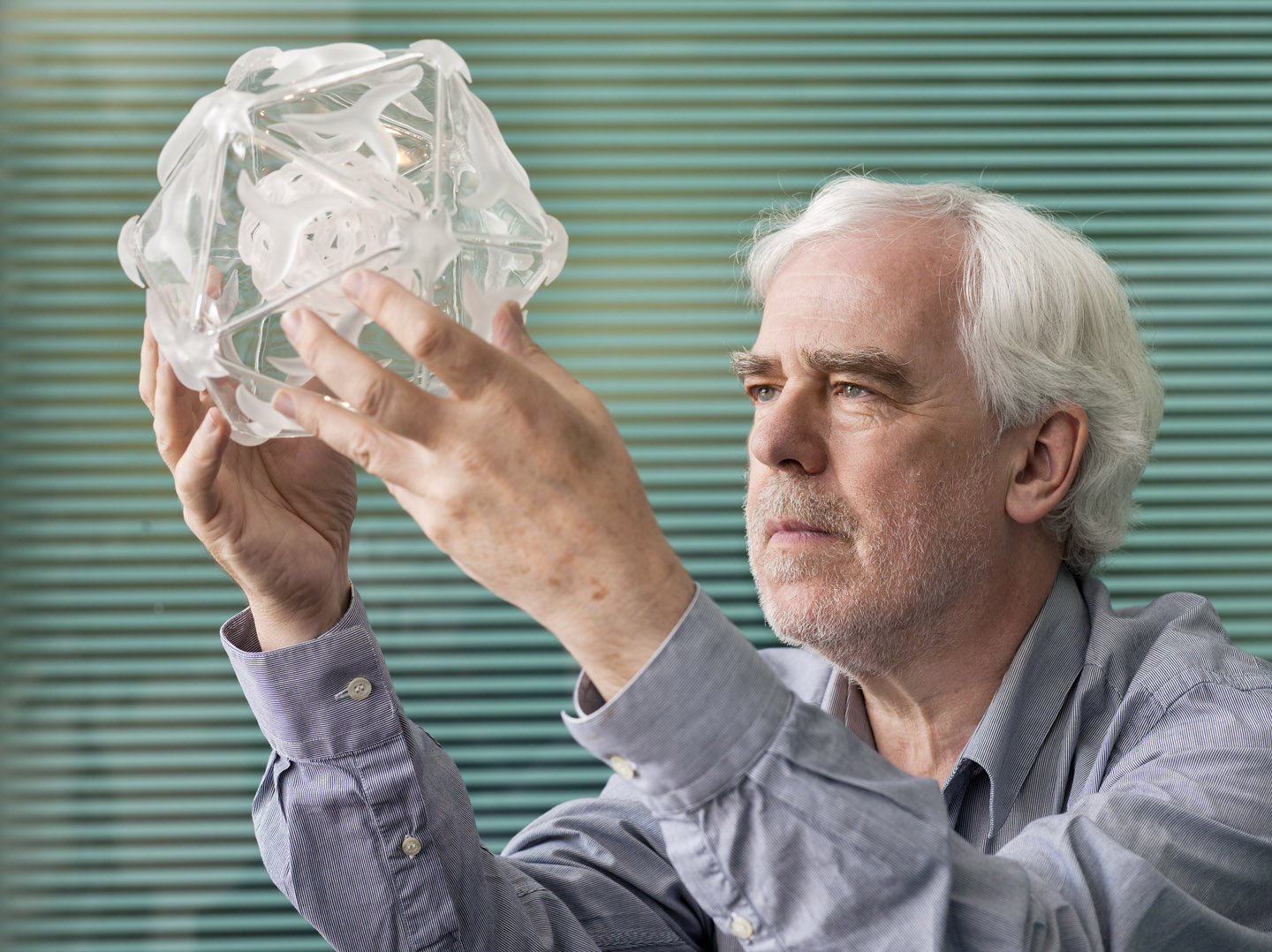 Professor Dave Stuart, holding Virus EV71 glass art piece