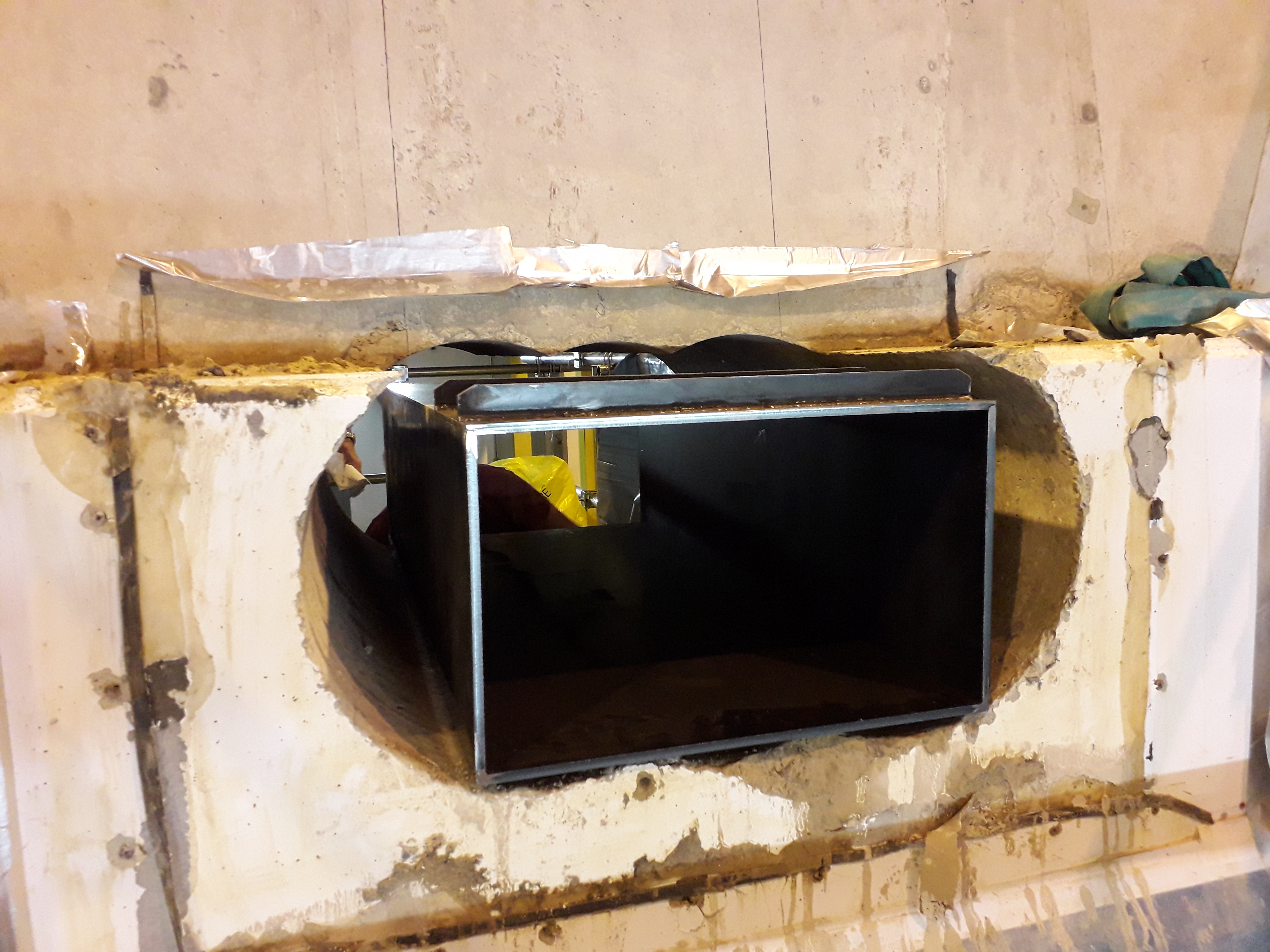 Hole stitch drilled through storage ring tunnel wall for RF Waveguides