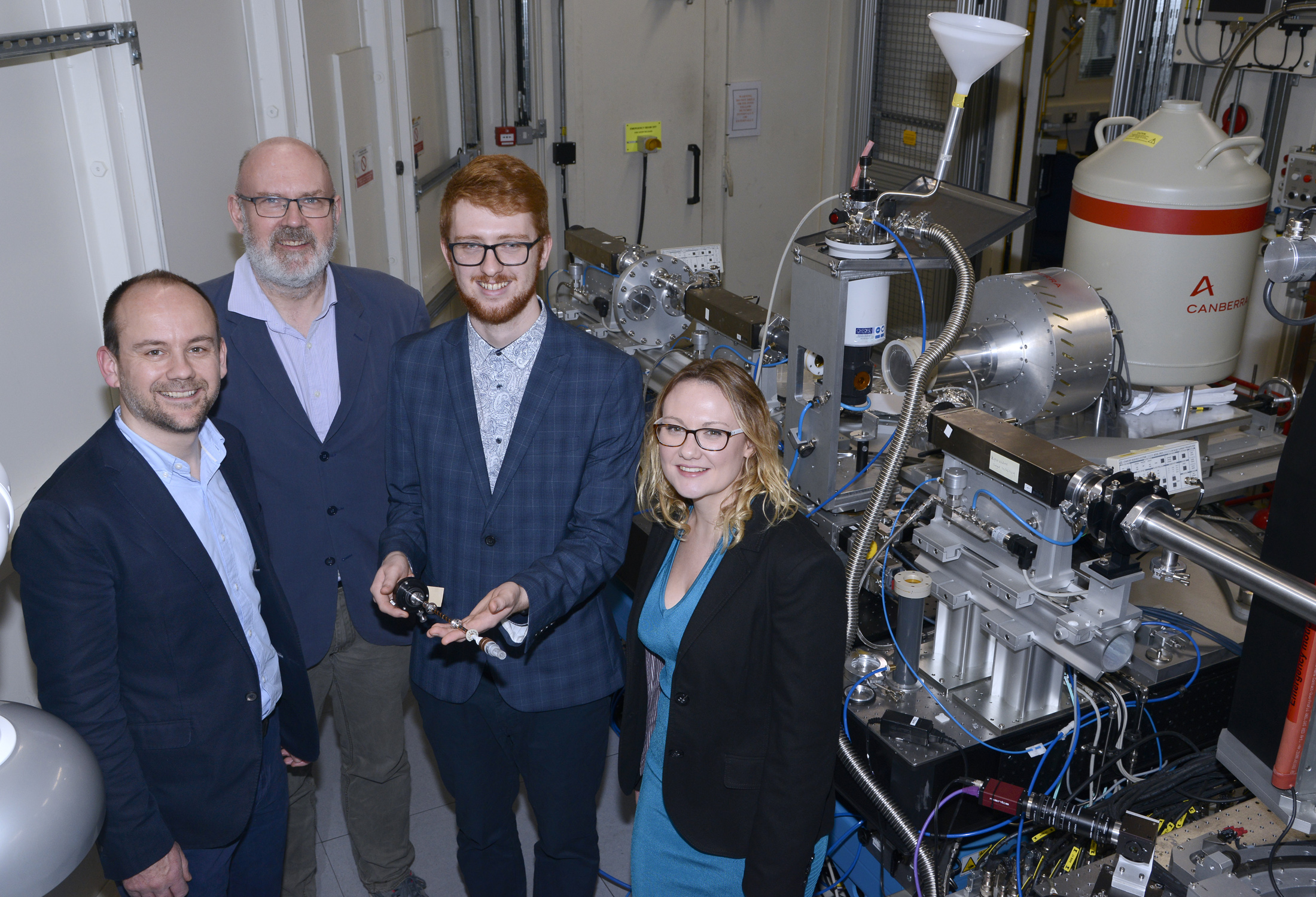 From left to right:  In Diamond’s I20-scanning beamline: Professor Sam Shaw, Co-Investigator and Professor of Environmental Mineralogy at the University of Manchester, Fred Mosselmans, Principal Beamline Scientist at beamline I20, Dr Luke Townsend, Postdoctoral Fellow in Environmental Radiochemistry at The University of Manchester holding a sample, and Dr Rosemary Hibberd, Senior Research Manager, Radioactive Waste Management