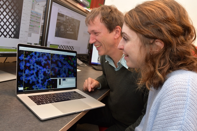 Dr Ivo Tews from Biological Sciences at the University of Southampton and joint Diamond-Southampton PhD student Rachel Bolton looking at electron density maps from their experiment.